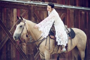bohemian-bride-wearing-white-lace-crochet-wedding-dress-on-horse