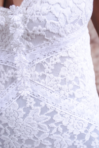 close-up-swatch-view-white-bohemian-wedding-dress-features-lace-panels-and-train