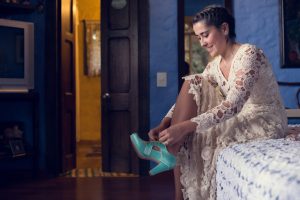 Amalia-wearing-isis-bohemian-wedding-dress-and-blue-vintage-shoes