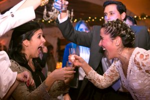 bride-and-wedding-guests-taking-shots-wearing-lace-dress
