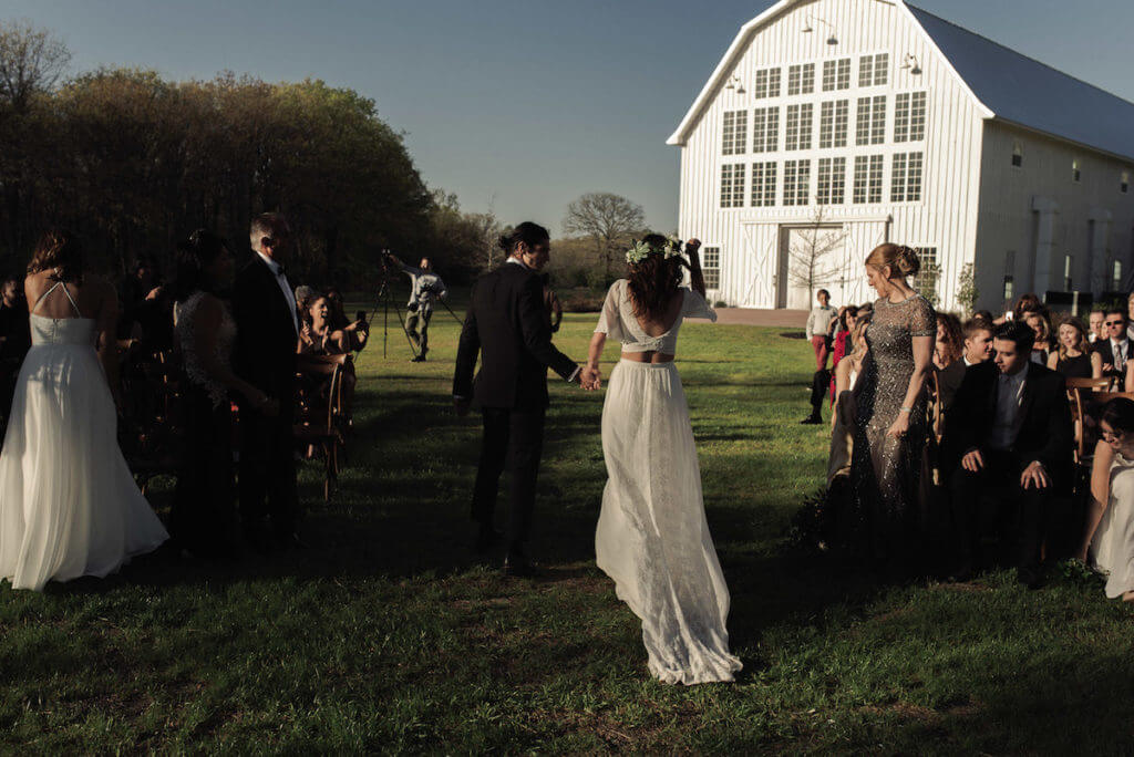 a-laidback-boho-bride-and-groom-at-their-barn-wedding-she-wears-two-piece-silk-lace-wedding-dress