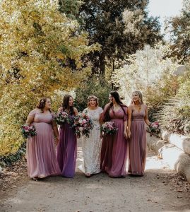 Bride and her bridesmaids wearing shades of purple