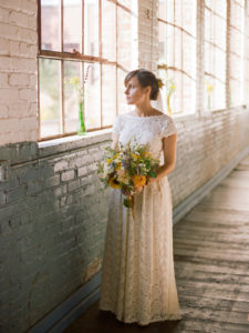bride-wearing-simple-elegant-catherine-lace-dress-with-open-back-and-pockets