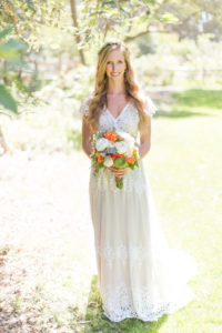 bride-alyssa-wearing-azalea-bohemian-wedding-dress-in-off-white-lace-with-sand-colored-silk-and-flowers-in-her-hair