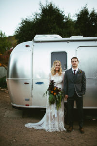 bride-megan-california-wedding-wearing-the-lisa-dress-standing-next-to-airbus