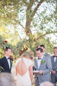 the-reading-of-the-vows-by-the-groom-in-a-dreamy-cherry-ranch-boho-wedding