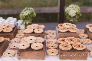 a-table-full-of-pies-at-a-farmhouse-bohemian-wedding