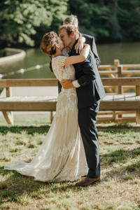 bohemian-couple-steal-a-kiss-at-their-laidback-camp-wedding-ceremony--she-wears-the-azalea-handmade-lace-wedding-dress