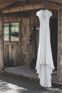 the-alice-dress-from-dreamers-and-lovers-shown-in-white-lace-with-long-train-backless-rustic