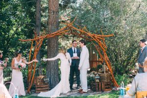 reading-at-bohemian-wedding-at-the-big-bear-lodge-bride-amy-wearing-dreamers-and-lovers-long-sleeved-wedding-dress-in-lace