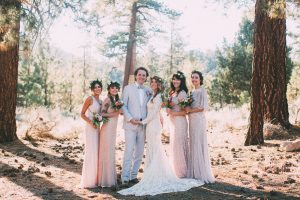 bride-and-groom-with-bridesamids-wearing-mismatched-bridesmaids-dresses-in-shades-of-blush