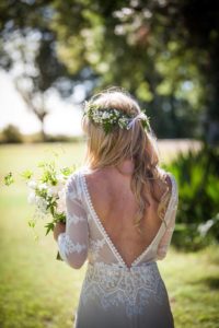 the-bride-in-a-backless-applique-lace-wedding-dress-adorned-with-long-sleeves-perfect-for-her-boho-chic-style