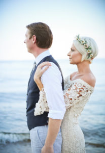 bride-wearing-holly-crochet-lace-wedding-dress-with-bell-sleeves-on-beach