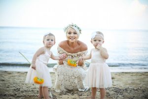 a-boho-bride-wearing-crochet-off-shoulder-lace-dress-with-her-little-flower-girls
