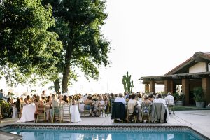 the-wedding-guests-gathered-beautifully-by-the-pool