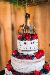 a-naked-cake-topped-with-berries-adds-a-rustic-boho-feel-to-the-wedding-day