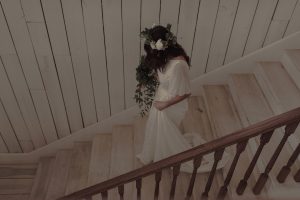 bride-saran-walking-down-the-stair-wearing-a-flower-crown-and-her-boho-wedding-dress