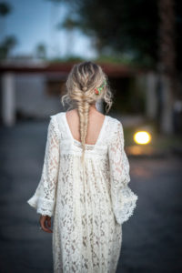 a-boho-bride-wearing-a-lace-caftan-with-a-gorgeous-fishtail-braid-and-flowers-in-her-hair