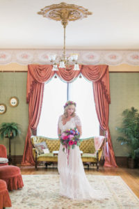 bohemian-bride-Caitlin-wearing-Azalea-vintage-inspired-lace-dress-carrying-a-colorful-bouquet