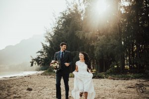 a-happy-bride-wearing-a-simple-bohemian-white-lace-dress-with-her-groom-hawaii-boho-beach-weddings