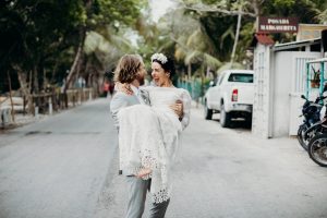 bride-Caroline-bohemian-chic-tulum-wedding-here-swept-up-by-her-groom-wearing-a-backless-lace-dress