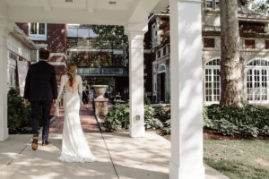 wedding-at-Glidden-House-groom-and-his-bride-dressed-in-a-backless-long-sleeved-lace-dress