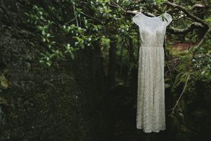 boho-bride-shay's-dreamers-and-lovers-bohemian-catherine-lace-wedding-dress-shown-hanging-amongst-the-trees