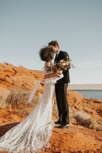 off-shoulder-wedding-dress-made-from-floral-cotton-lace-and-fringe-trimed-train-bohemian-inspo