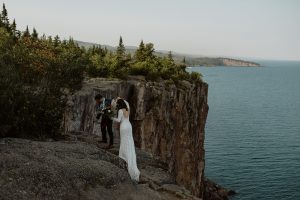 ntimate-lakeside-wedding-at-lake-superior-bride-wearing-long-sleeve-backless-dress