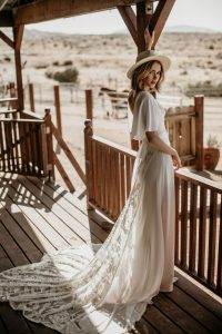 Hayley-lace-and-crepe-romantic-wedding-dress-with-cape-sleeves-dreamy-train-and-low-cut-neckline