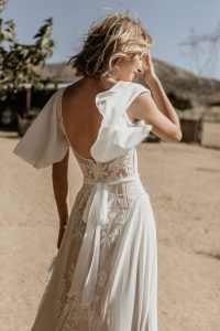 Plunge-back-Hayley-lace-and-crepe-romantic-wedding-dress-with-flowy-cape-sleeves