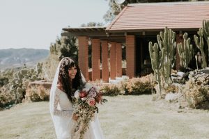 Bride-Amanda-wearing-bohemian-wedding-dress-with-bell-sleeves-at-Condor's-Nest-Ranch