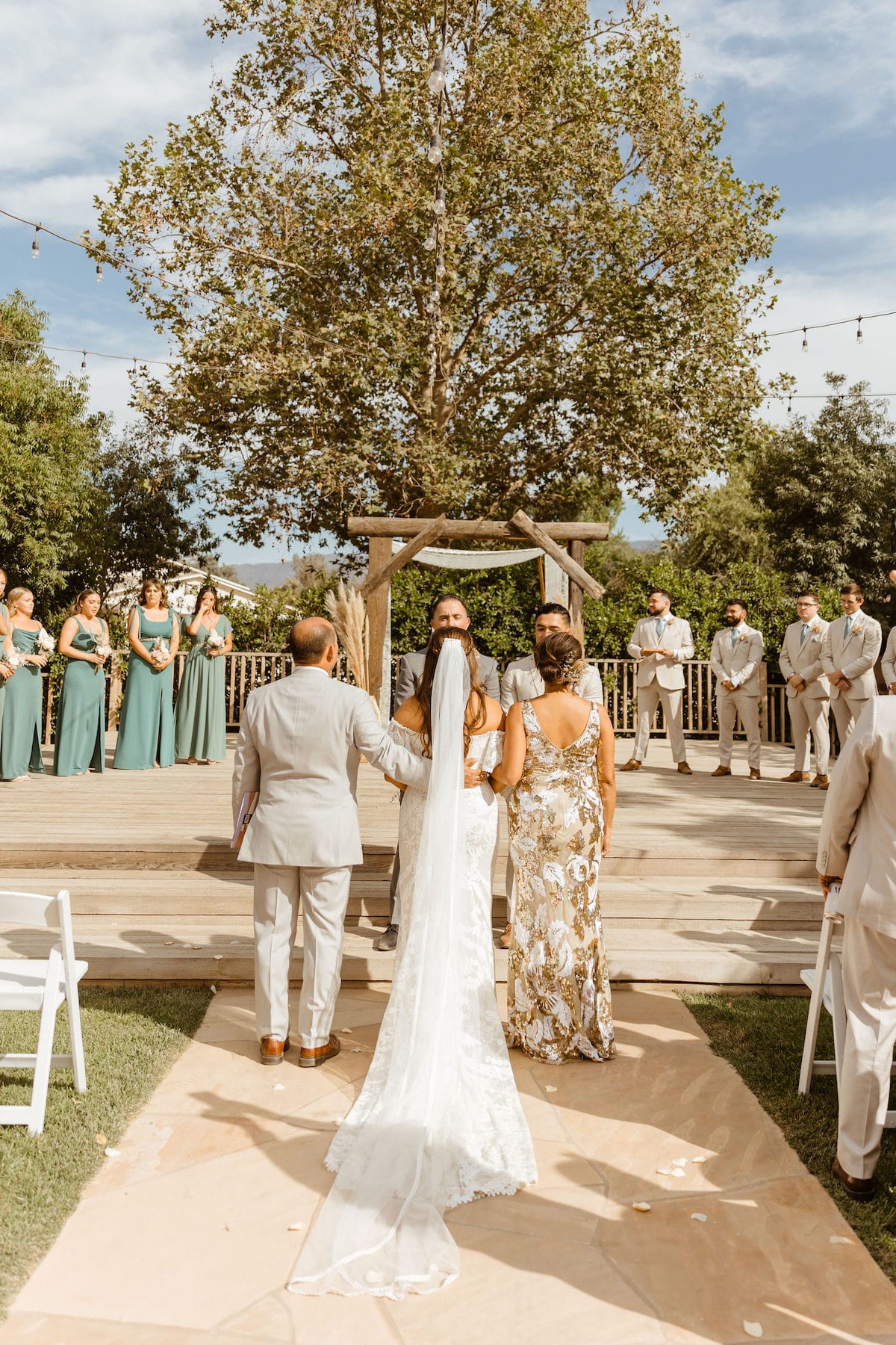 Emily-walks-down-the-aisle-with-both-parents