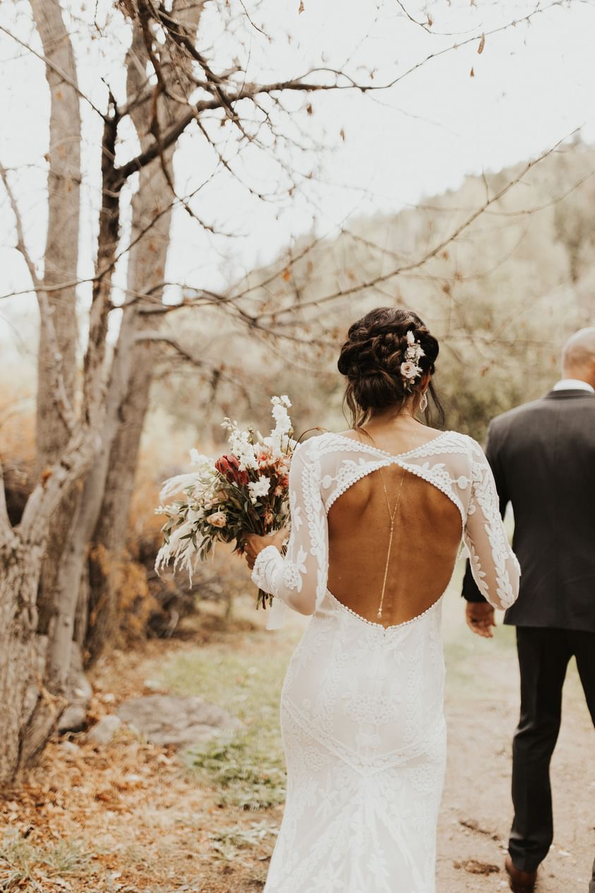 Bride-wearing-open-back-boho-long-sleeve-wedding-dress