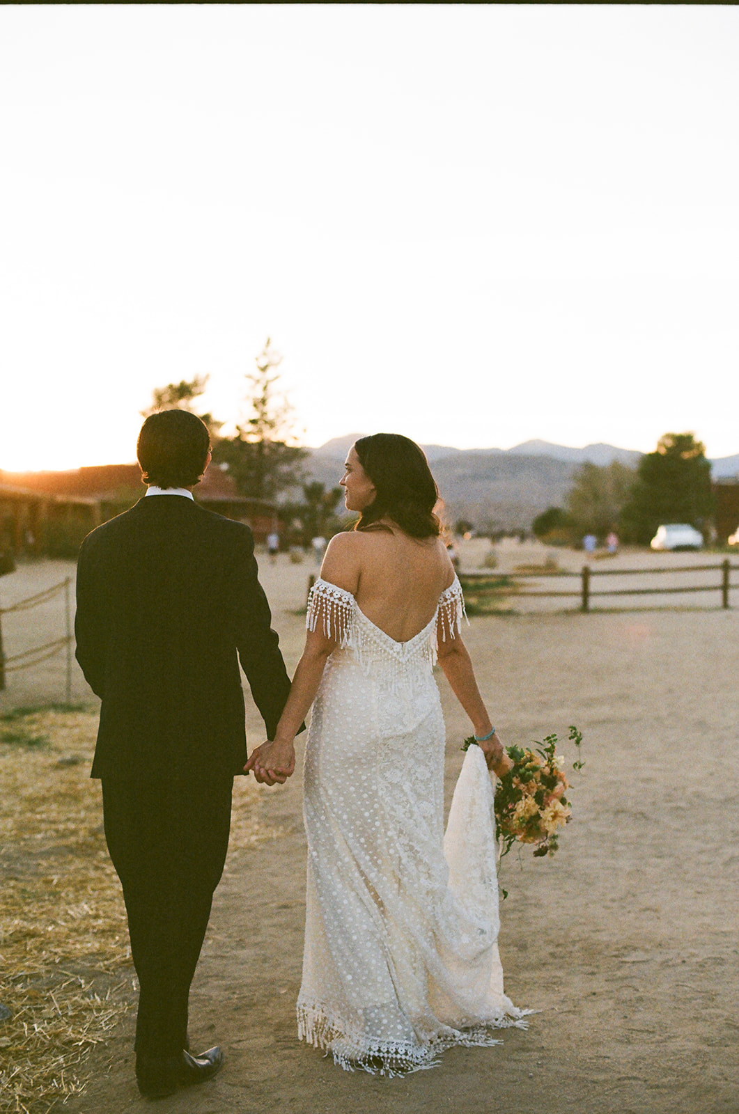 Bride wearing the Heather fringe wedding dress for her western wedding