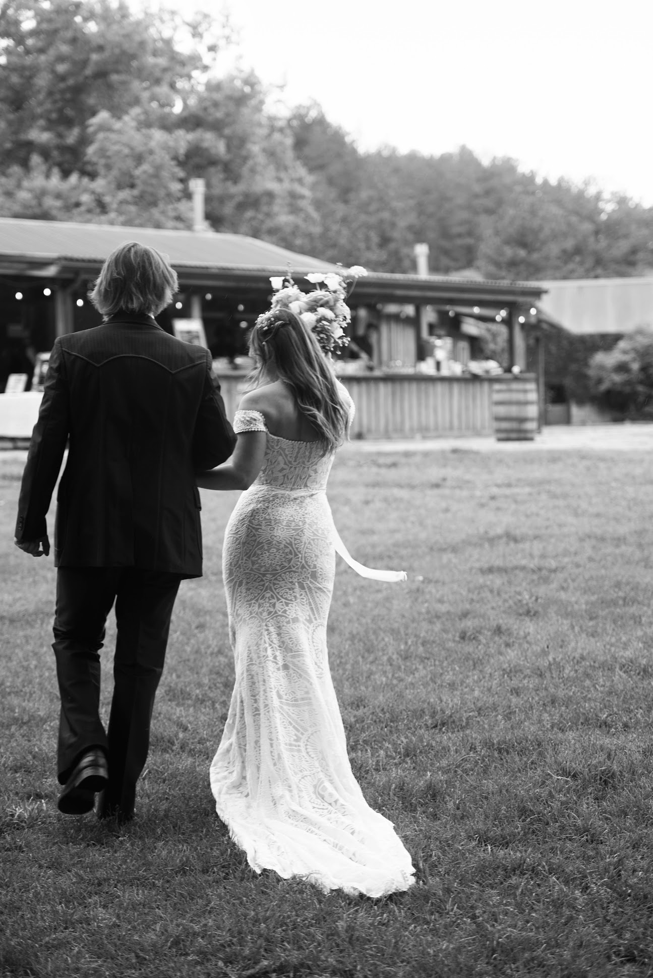 Bride Ashley wearing the off-shoulder Phoebe lace wedding dress