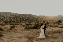 Bride Allison wearing Lisa | Randi Kreckman Photography joshua-tree-wedding-bride-waering-romantic-backless-lace-boho-wedding-dress