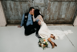 Chloe wearing Florence Gown | Photo: Swatch Studios boho-bride-wearing-backless-dotted-embroidery-lace-gown-with-scattered-floral-appliques