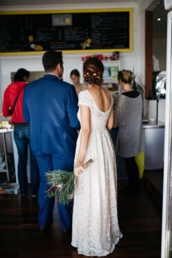 Bride Sarah in Catherine with custom raised back bohemian-bride-sarah-in-a-cafe-in-australia-wearing-dreaamers-and-overs-catherine-dress