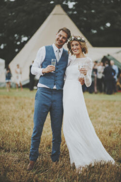 an-English-bride-in-a-simple-long-eleeve-backless-wedding-dress-and-the-groom-in-a-two-piece-blue-suit