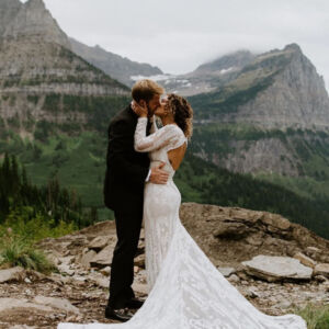 Real Bride in the Mountains wearing a Long Sleeve Lace Wedding Dress with Open Back