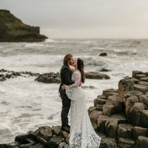 Real Bride wearing a Lace romantic bohemian wedding dress in Iceland next to the water